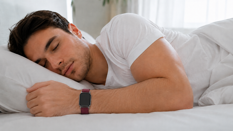 A man wearing a Fitzap5 watch is sleeping.